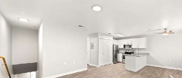 Open-concept kitchen and living area inside an Oasis Palms apartment